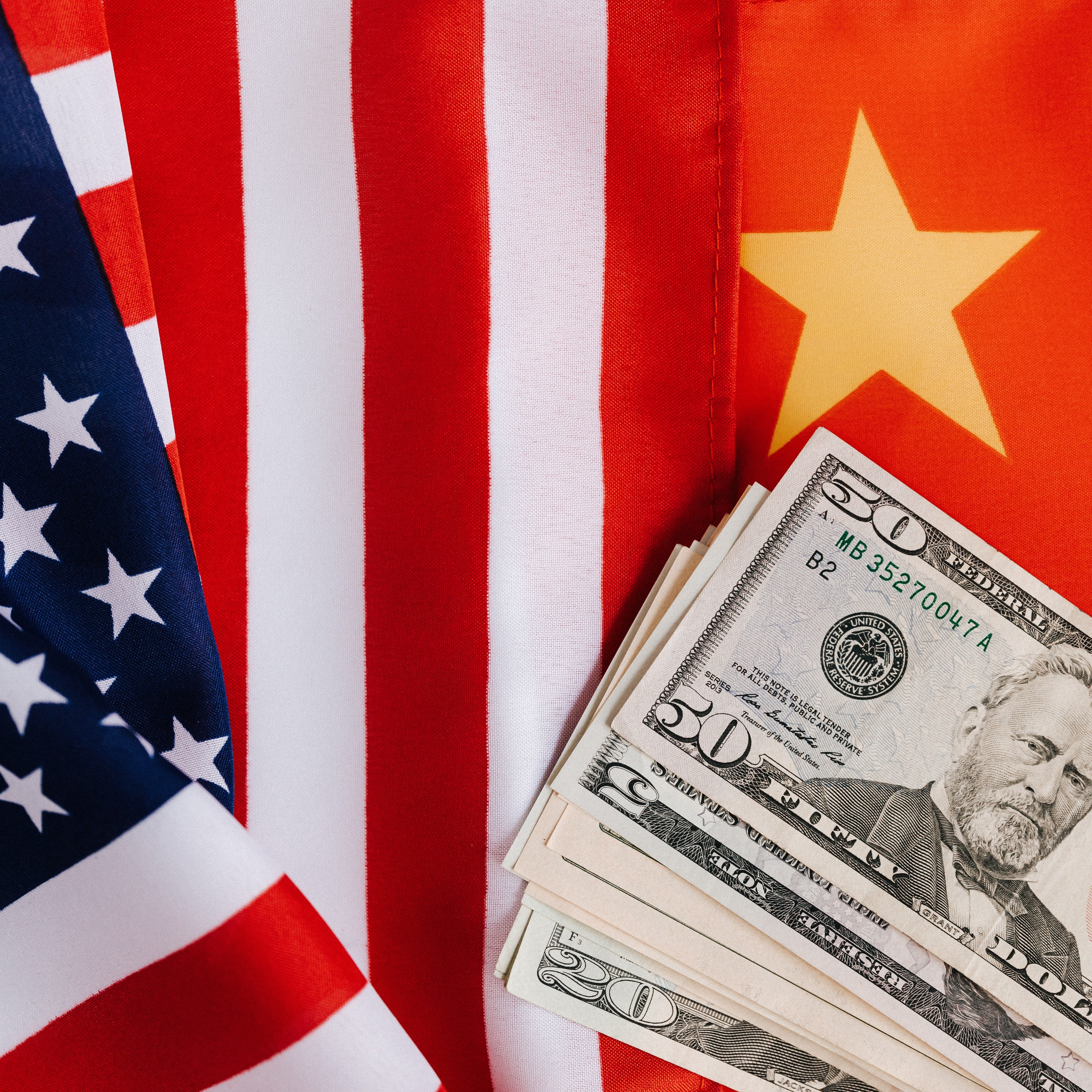 https://www.pexels.com/photo/american-and-chinese-flags-and-usa-dollars-4386371/